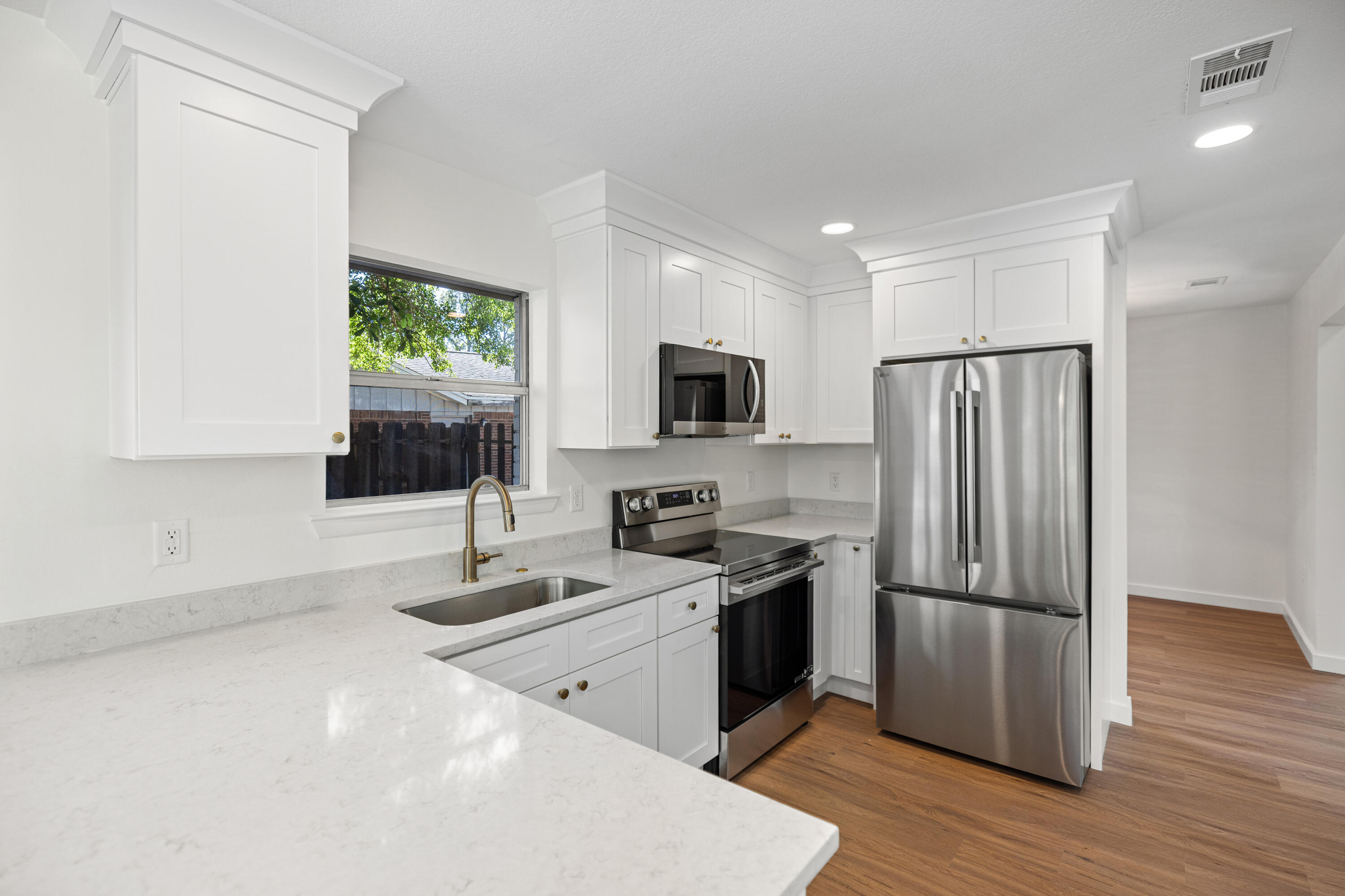 103 Perdido Circle Niceville, FL 32578 - Photo 21 of 71 a kitchen with granite countertop a refrigerator stove and microwave