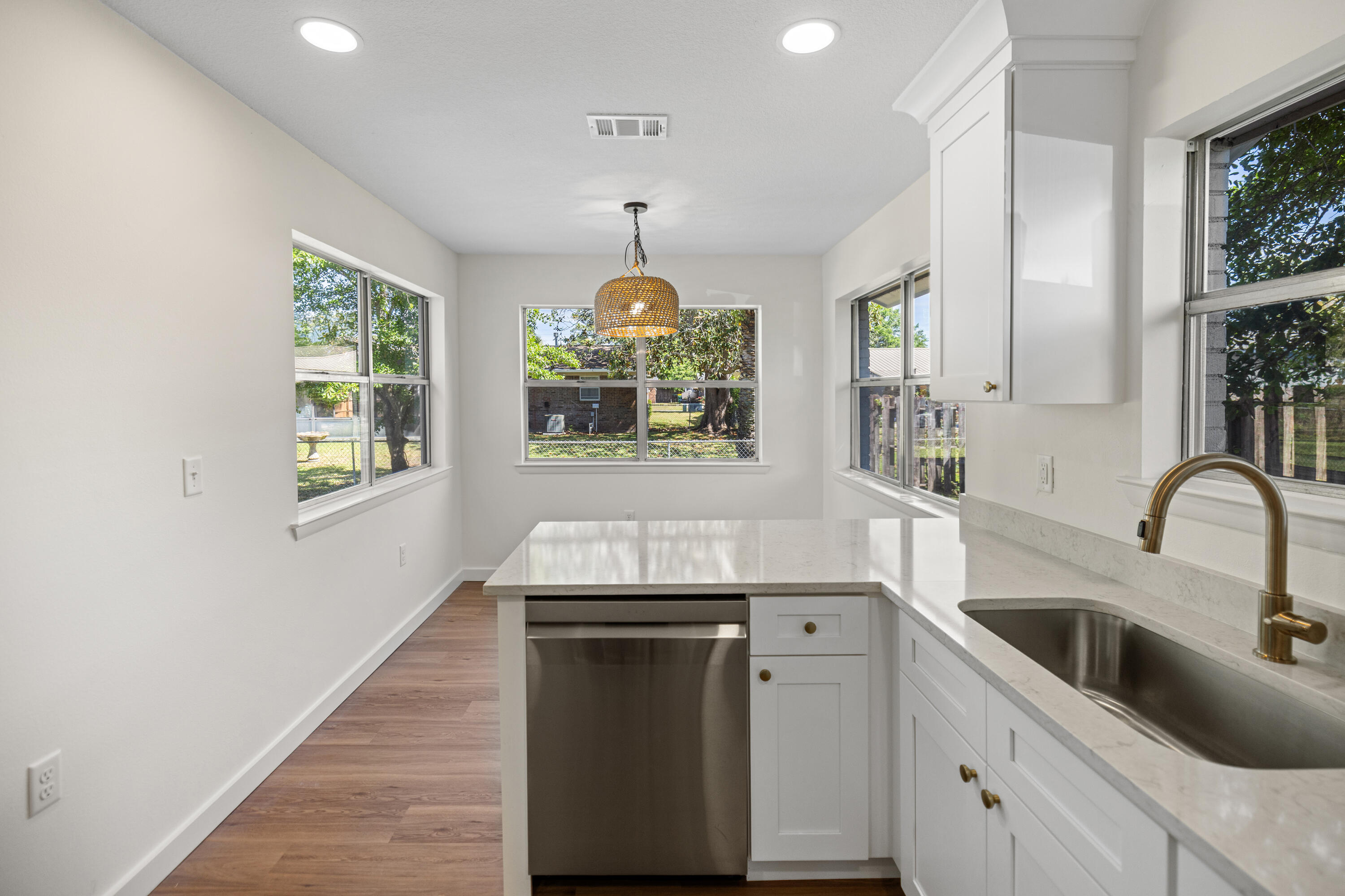 103 Perdido Circle Niceville, FL 32578 - Photo 34 of 71 a kitchen with stainless steel appliances granite countertop a sink cabinets a stove and a window