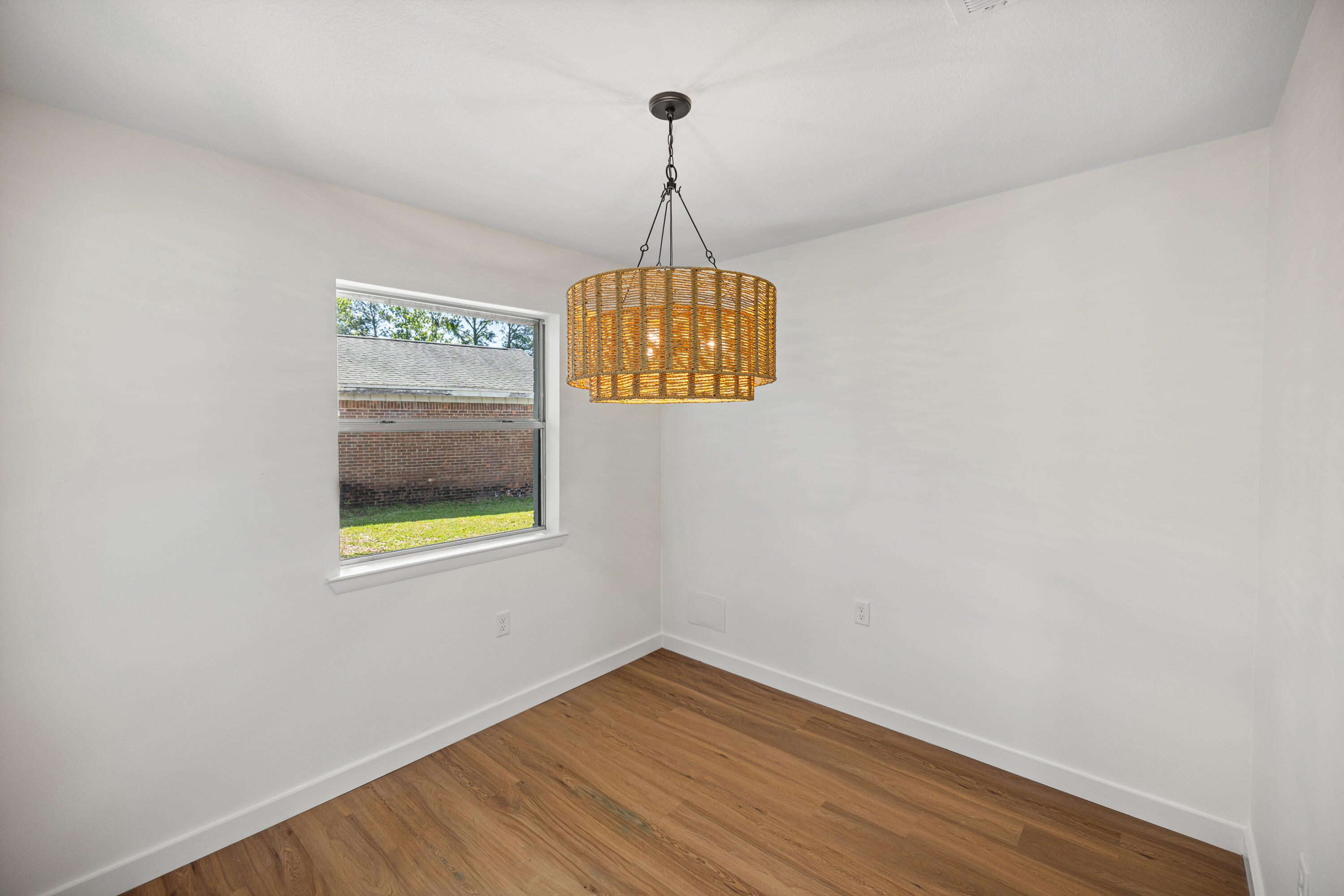 103 Perdido Circle Niceville, FL 32578 - Photo 36 of 71 a view of an empty room with window and wooden floor