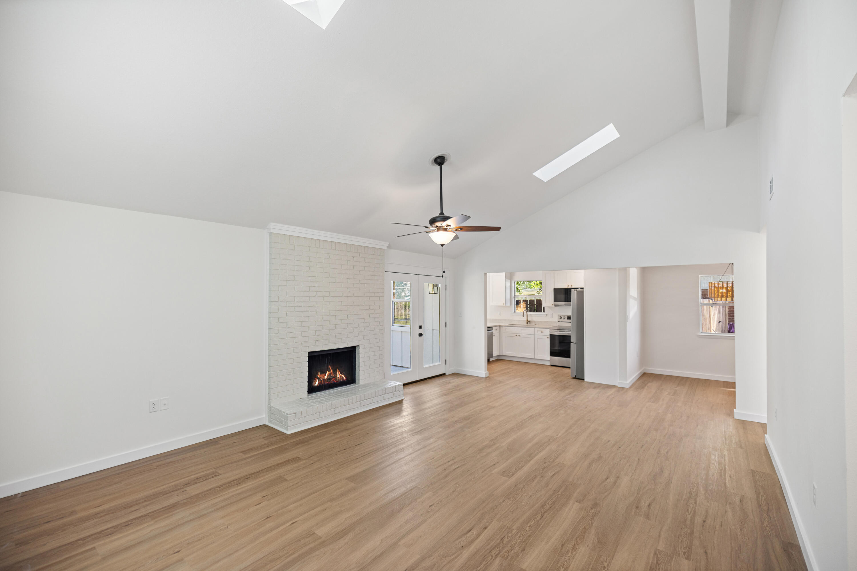103 Perdido Circle Niceville, FL 32578 - Photo 6 of 71 a view of a livingroom with wooden floor and a ceiling fan