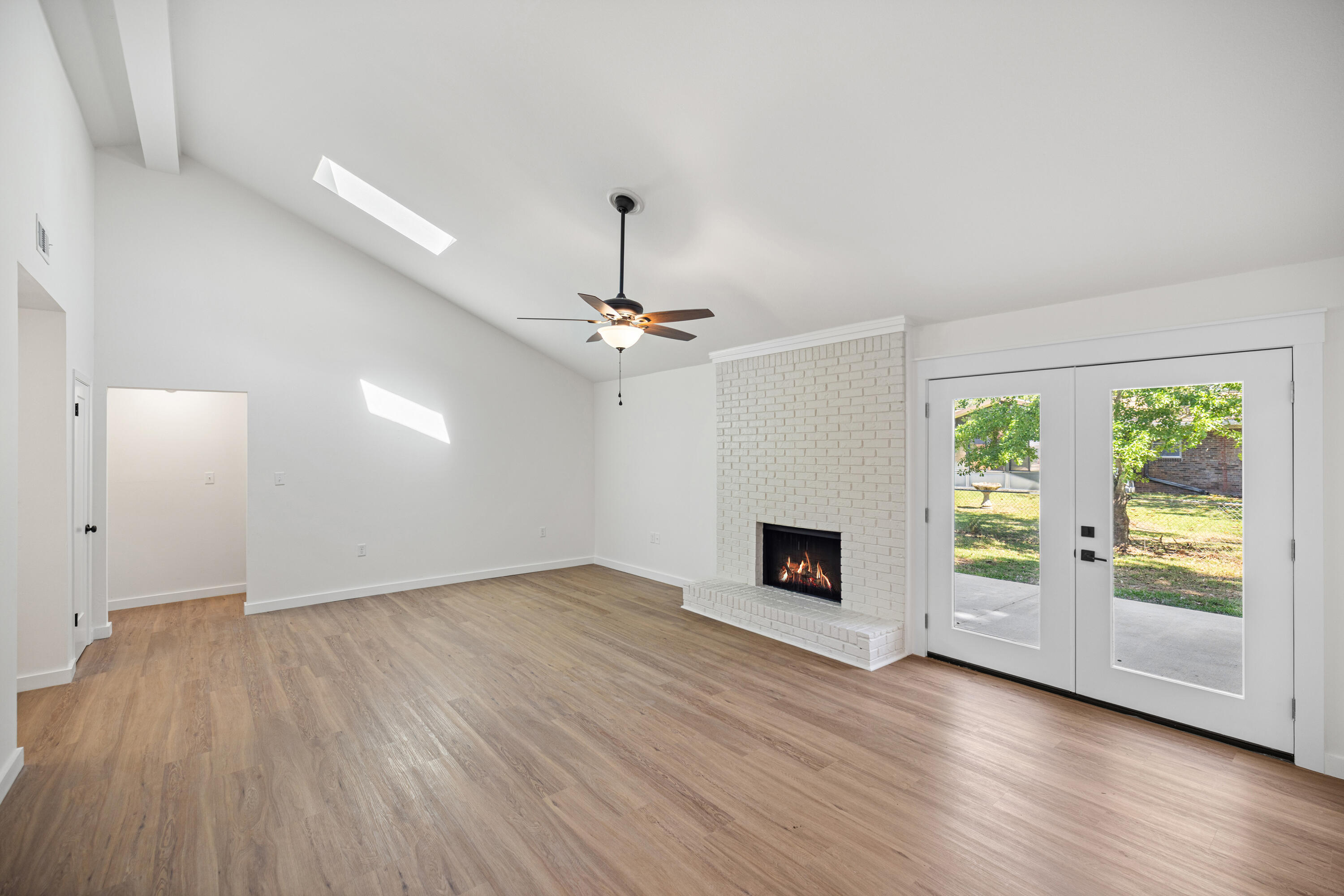 103 Perdido Circle Niceville, FL 32578 - Photo 8 of 71 an empty room with wooden floor fireplace and windows