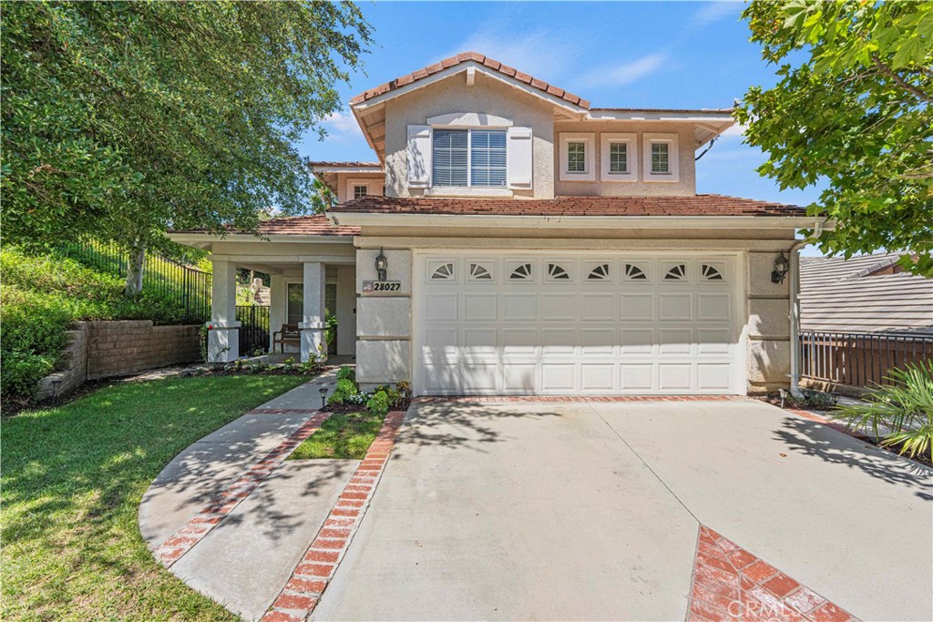 28027 Cascade Road Castaic, CA 91384 - Photo 1 of 1 a front view of a house with a yard and garage