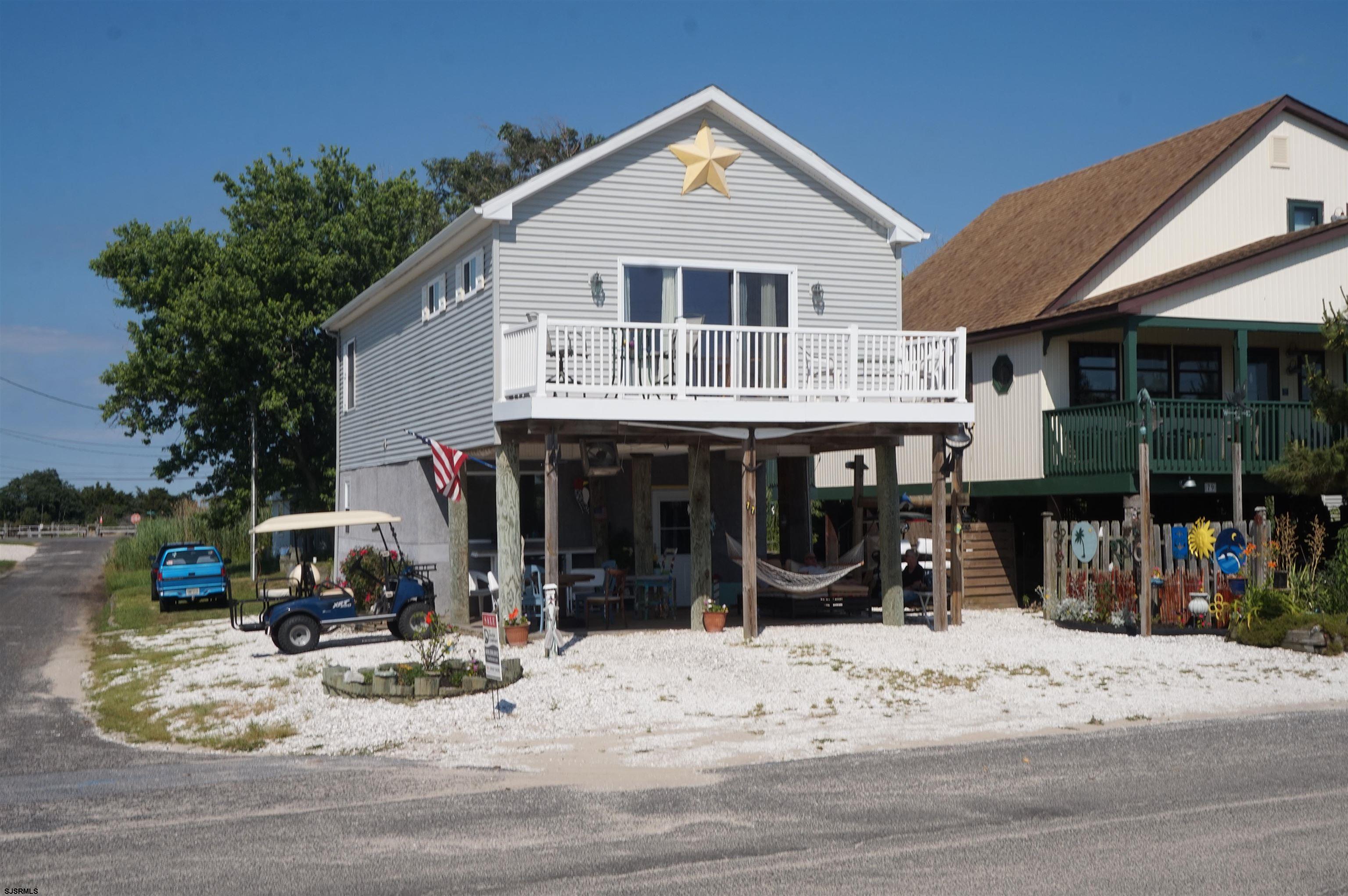 a view of a small house in the middle of a yard