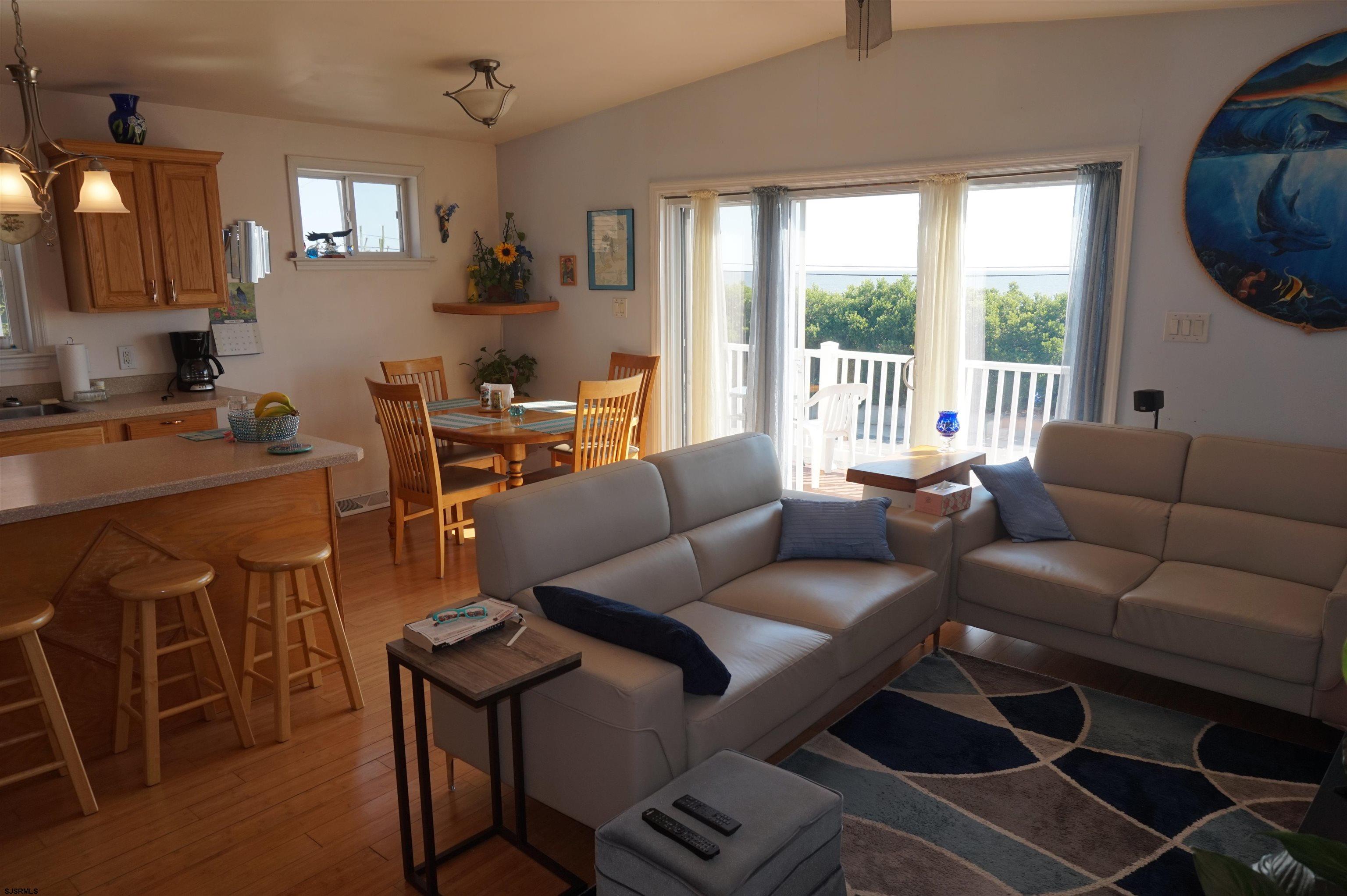77 Delaware Avenue Fortescue, NJ 08321 - Photo 11 of 47 a living room with furniture a large window and a dining table