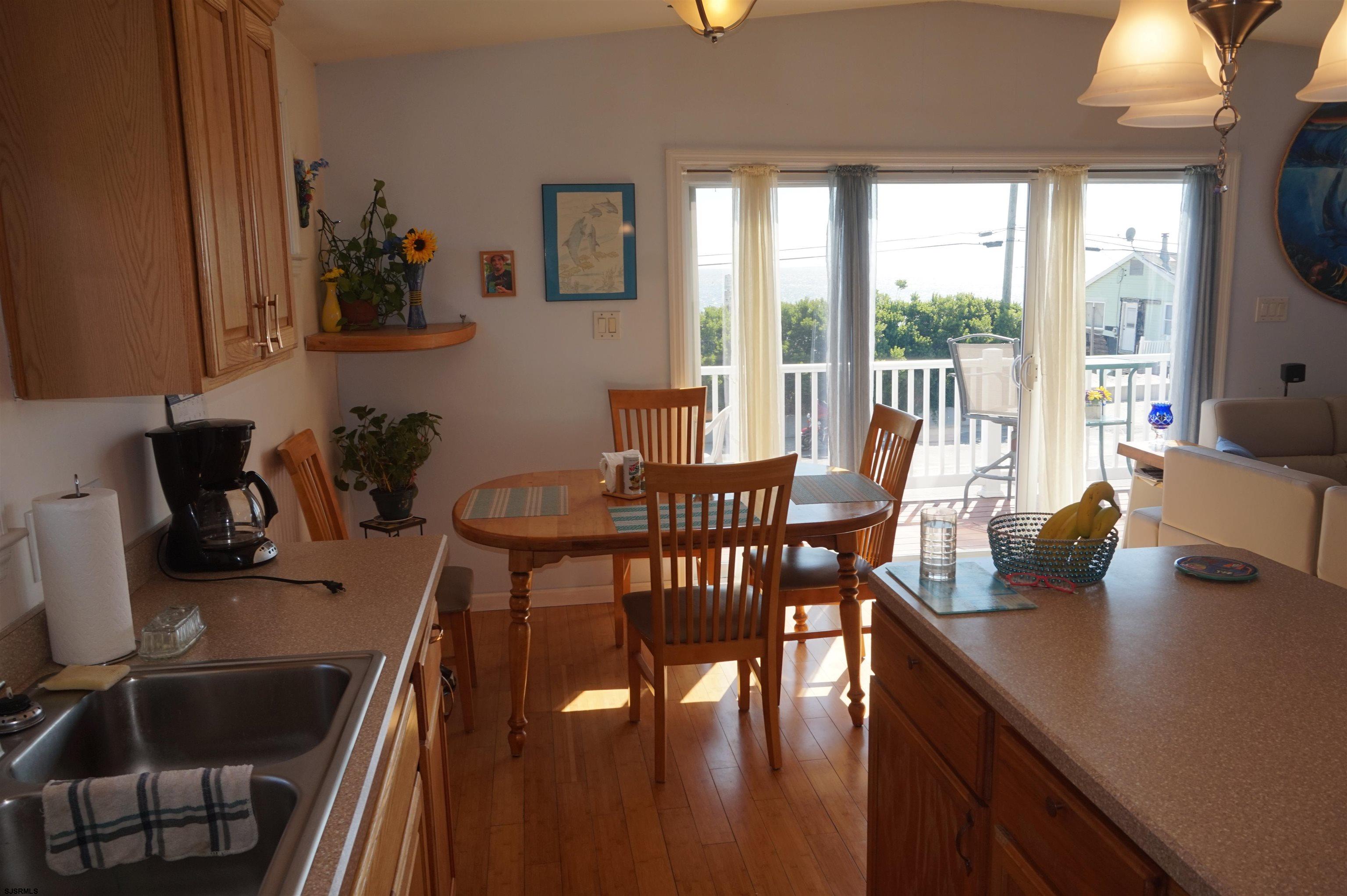 77 Delaware Avenue Fortescue, NJ 08321 - Photo 15 of 47 a dining room with furniture a chandelier and wooden floor
