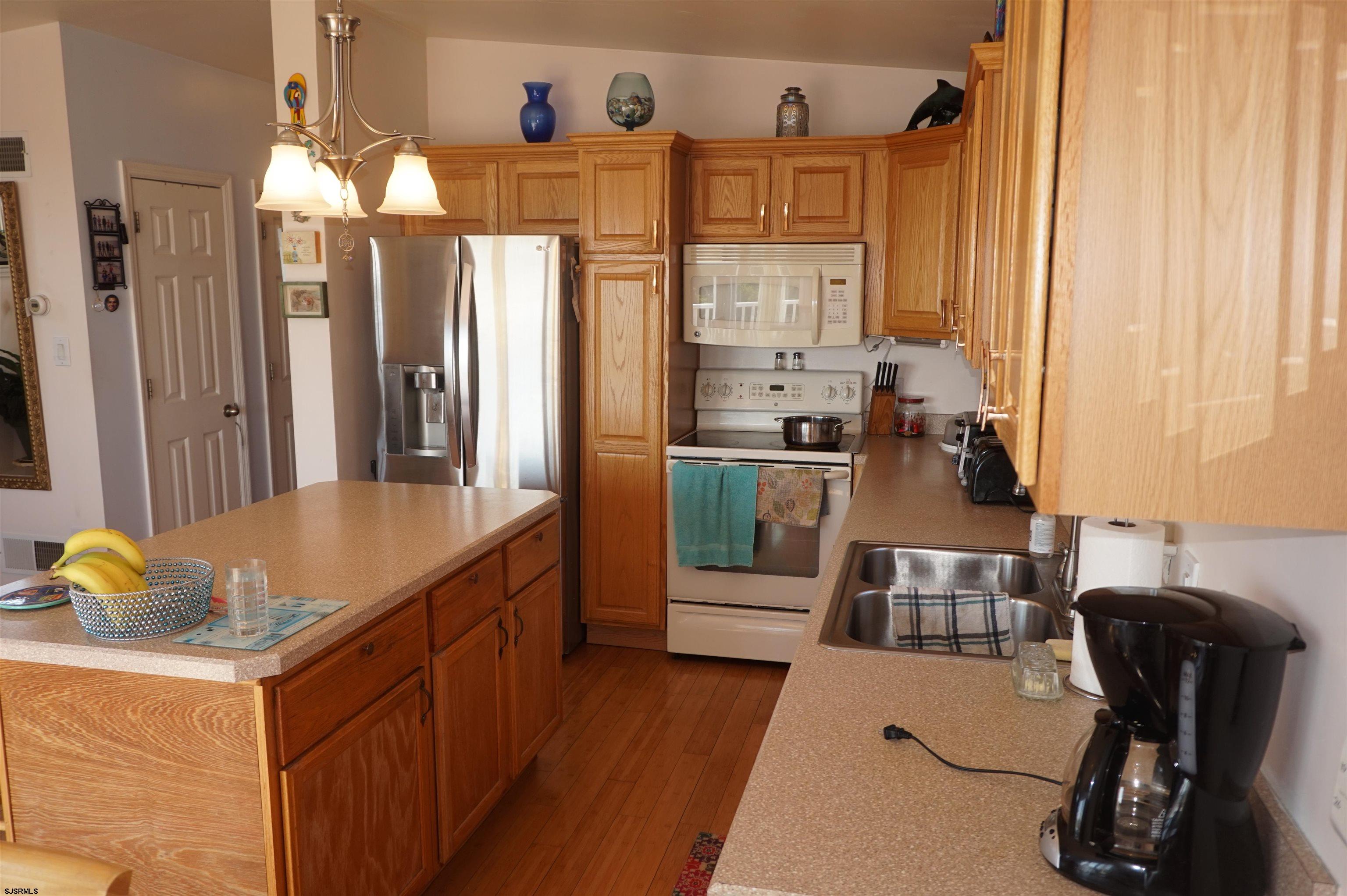 77 Delaware Avenue Fortescue, NJ 08321 - Photo 16 of 47 a kitchen with stainless steel appliances granite countertop a sink a stove and a refrigerator