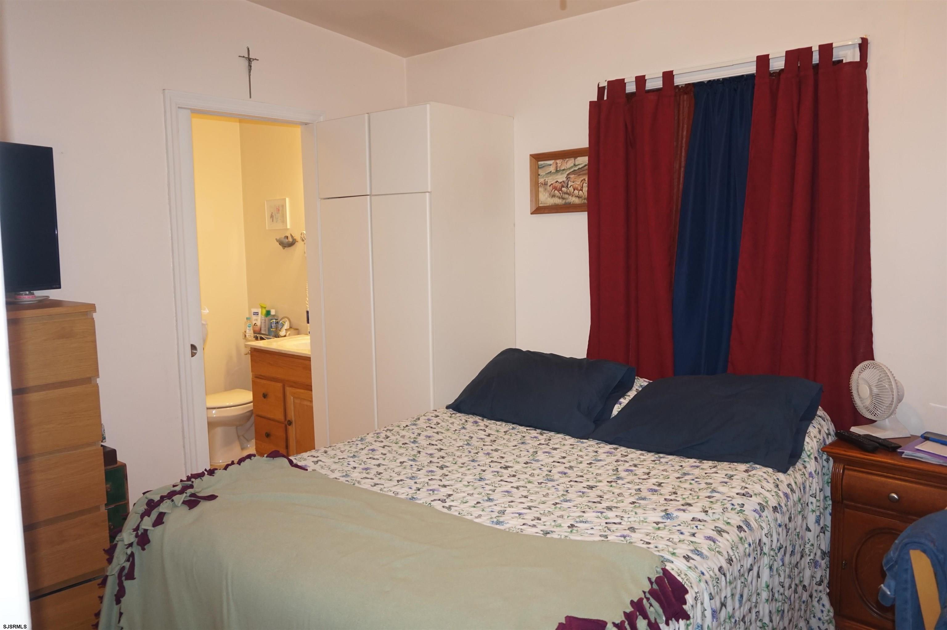 77 Delaware Avenue Fortescue, NJ 08321 - Photo 18 of 47 a bedroom with a bed and wooden floor