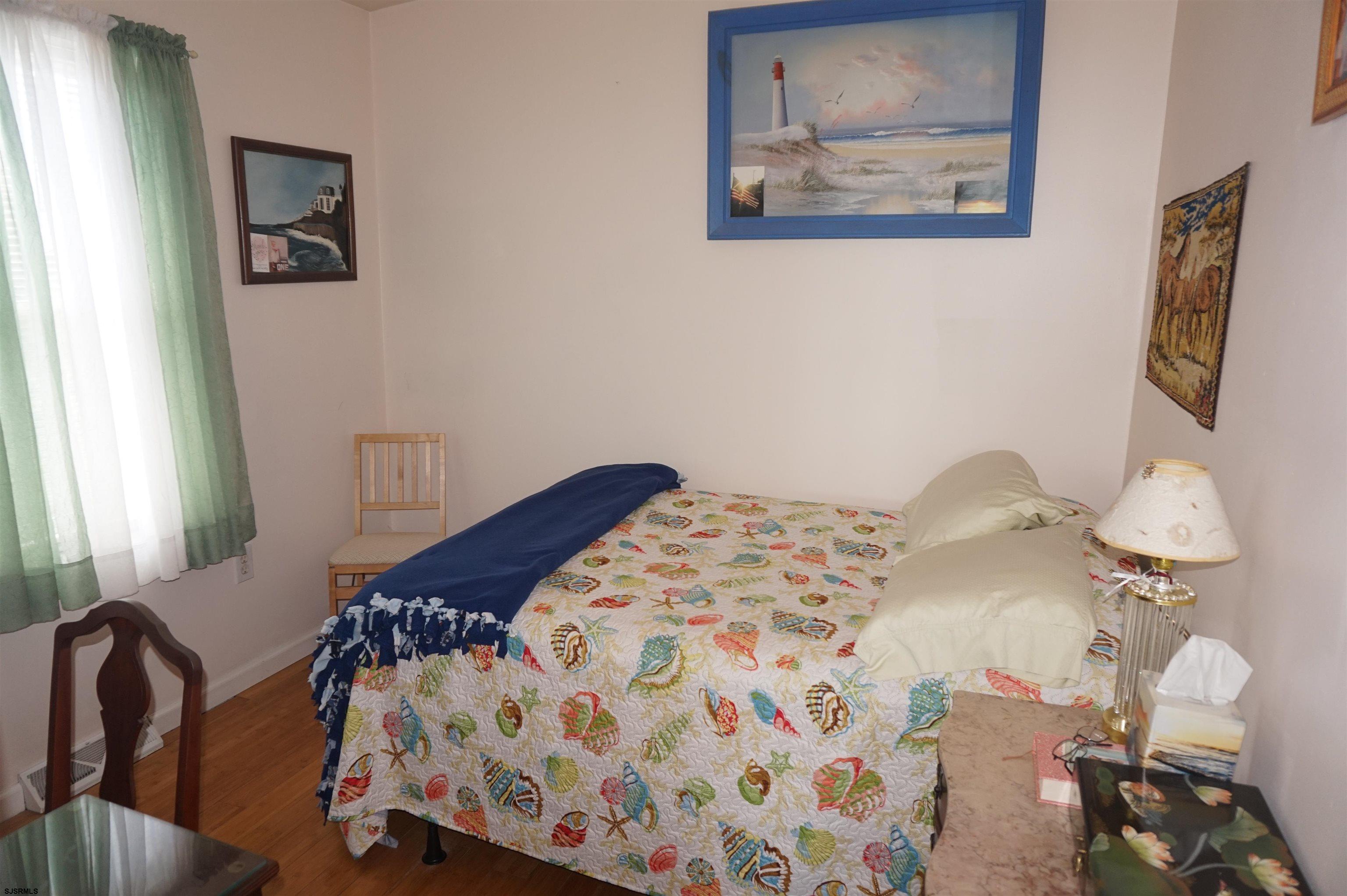 77 Delaware Avenue Fortescue, NJ 08321 - Photo 19 of 47 a bedroom with a bed and a lamp