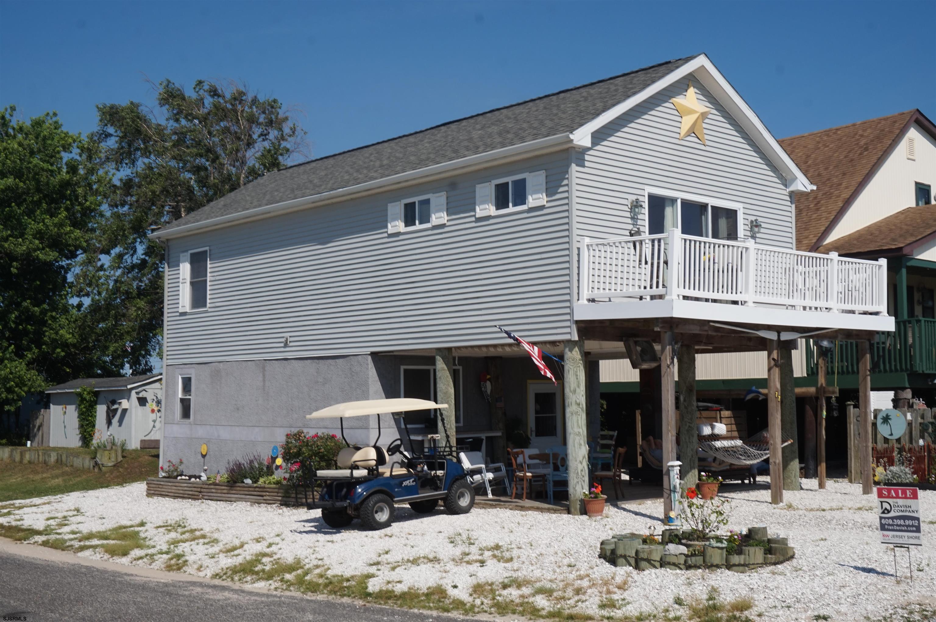 77 Delaware Avenue Fortescue, NJ 08321 - Photo 2 of 47 a front view of a house with a patio