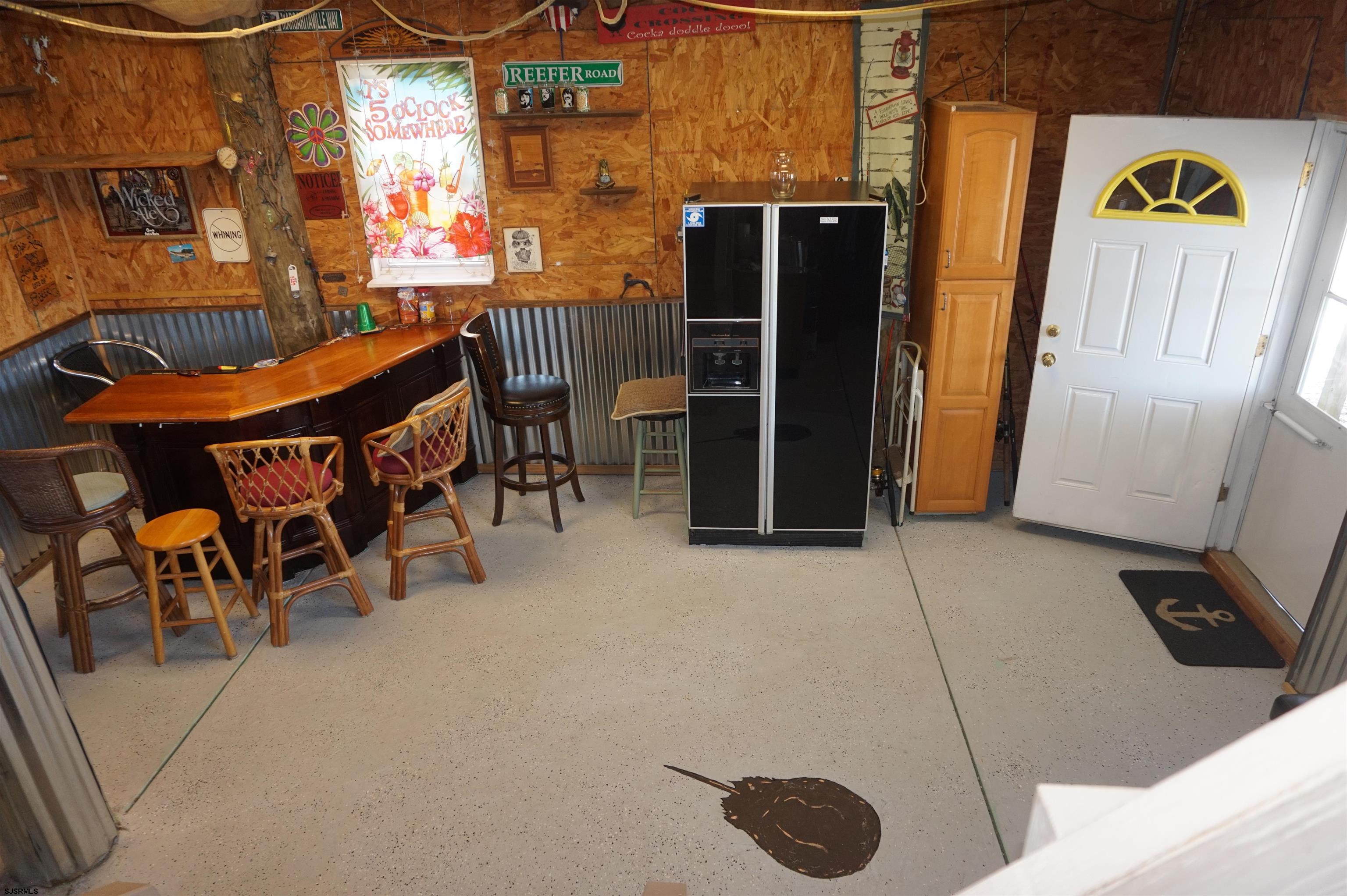 77 Delaware Avenue Fortescue, NJ 08321 - Photo 26 of 47 a view of a patio with table and chairs