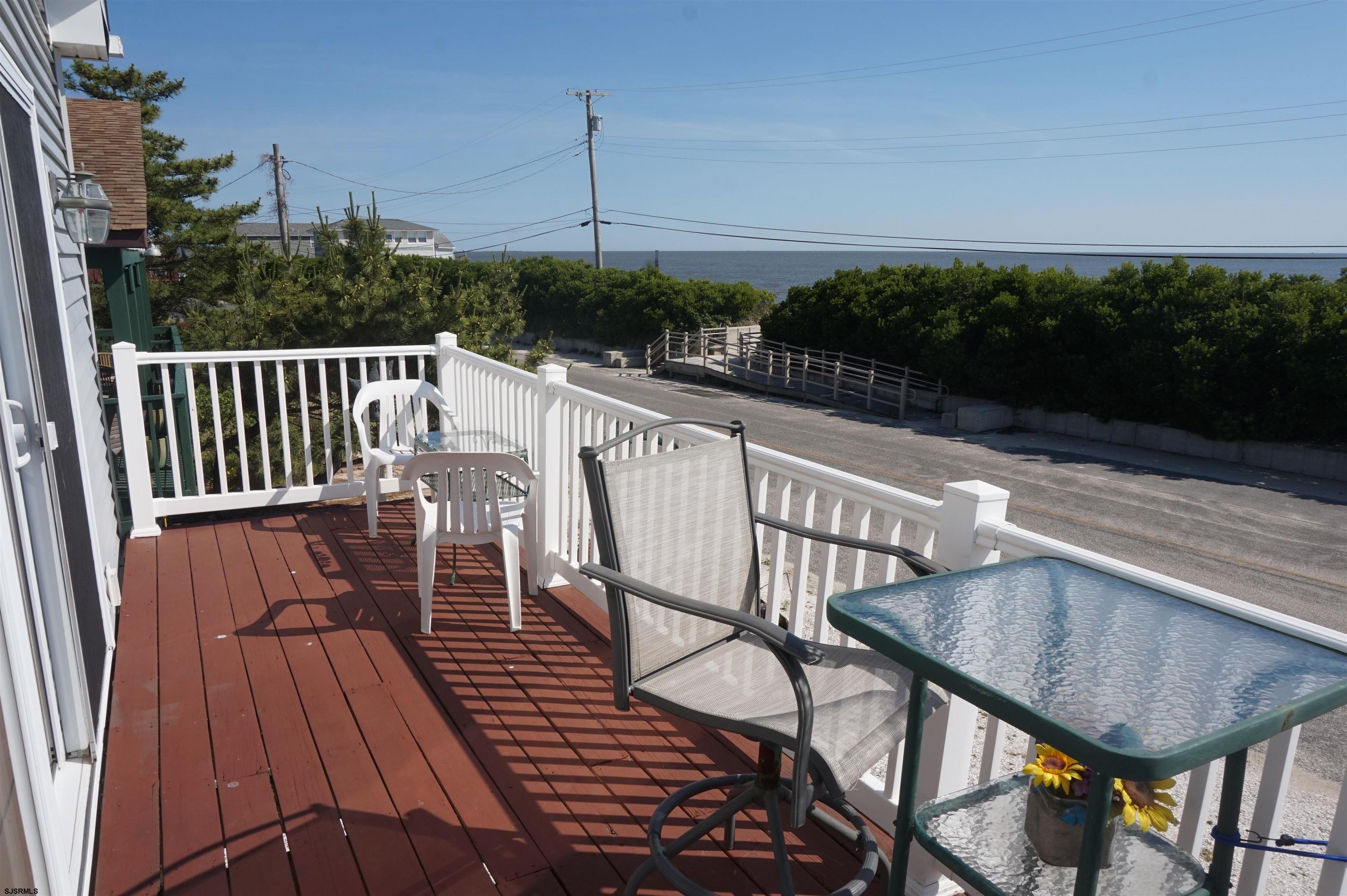77 Delaware Avenue Fortescue, NJ 08321 - Photo 36 of 47 a view of a balcony with wooden floor and outdoor seating