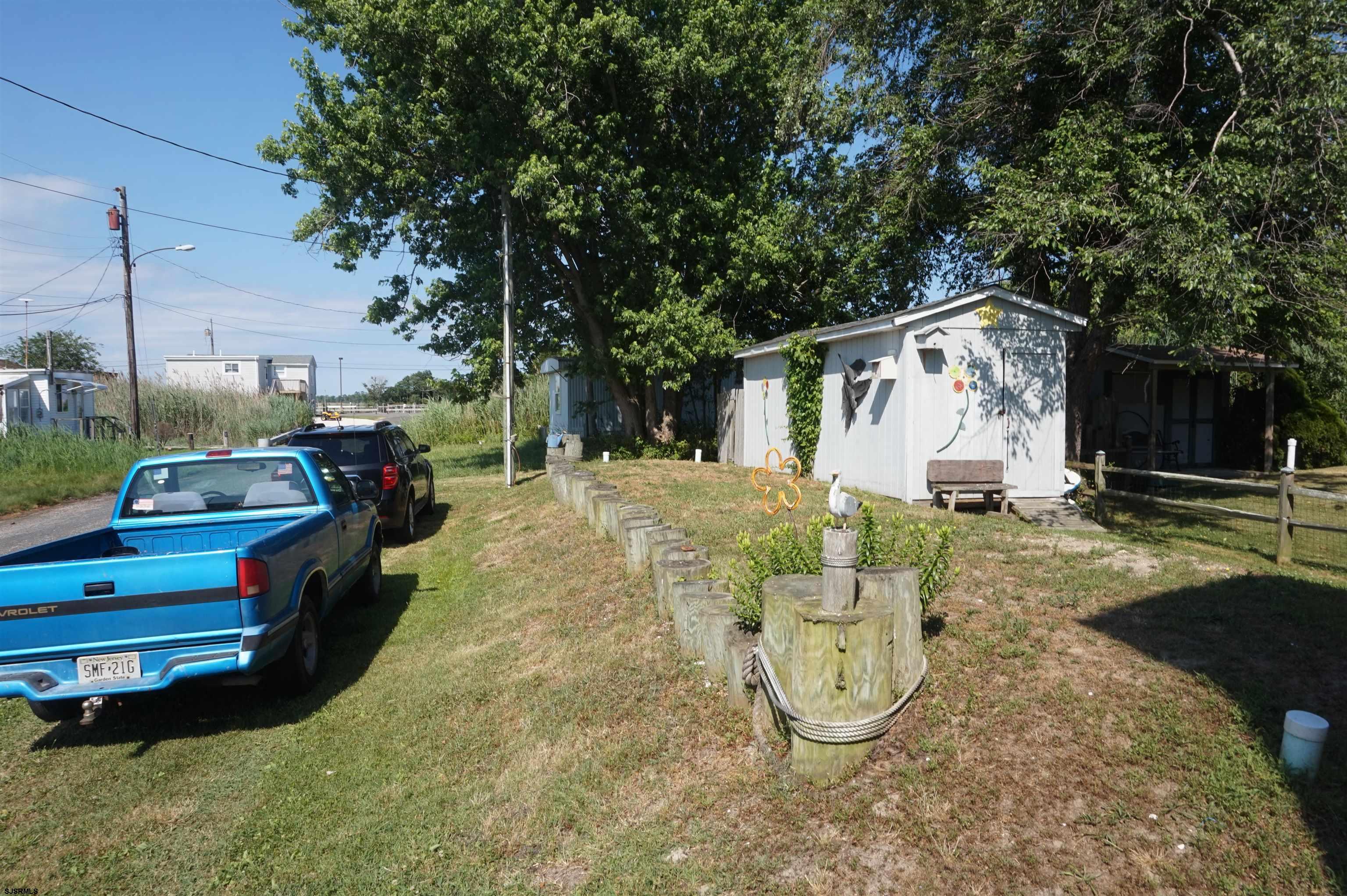 77 Delaware Avenue Fortescue, NJ 08321 - Photo 37 of 47 a view of a chair and table in backyard