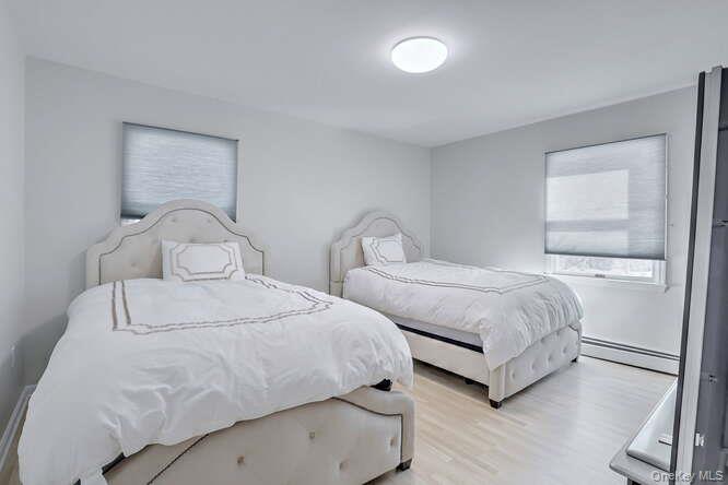 89 Spook Rock Road Suffern, NY 10901 - Photo 22 of 44 a bedroom with two beds and white walls