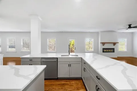 a view of a kitchen with wooden floor and staircase