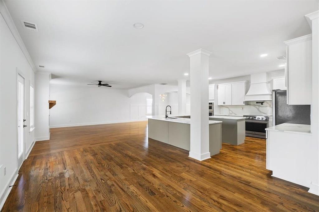 222 Silvercrest Drive Acworth, GA 30101 - Photo 15 of 73 a large white kitchen with kitchen island a sink a stove and white cabinets