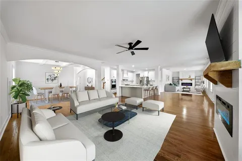 a view of a livingroom with wooden floor and white walls