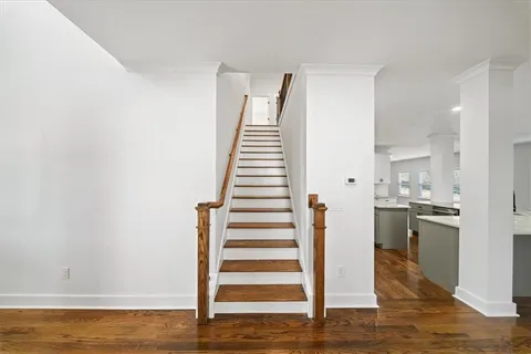 a bathroom with a double vanity sink and mirror with bathtub