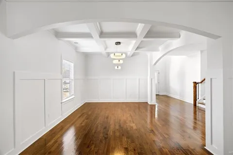 a bedroom with a large bed and a chandelier