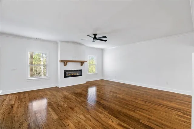 a bedroom with a large bed and a ceiling fan