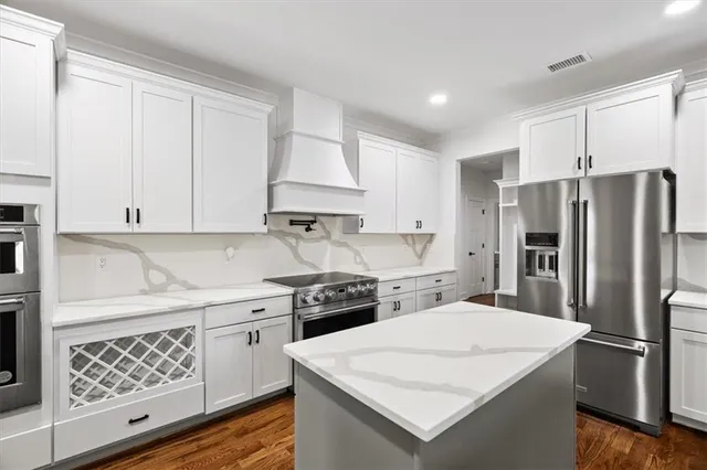 a kitchen with a sink a stove and a refrigerator