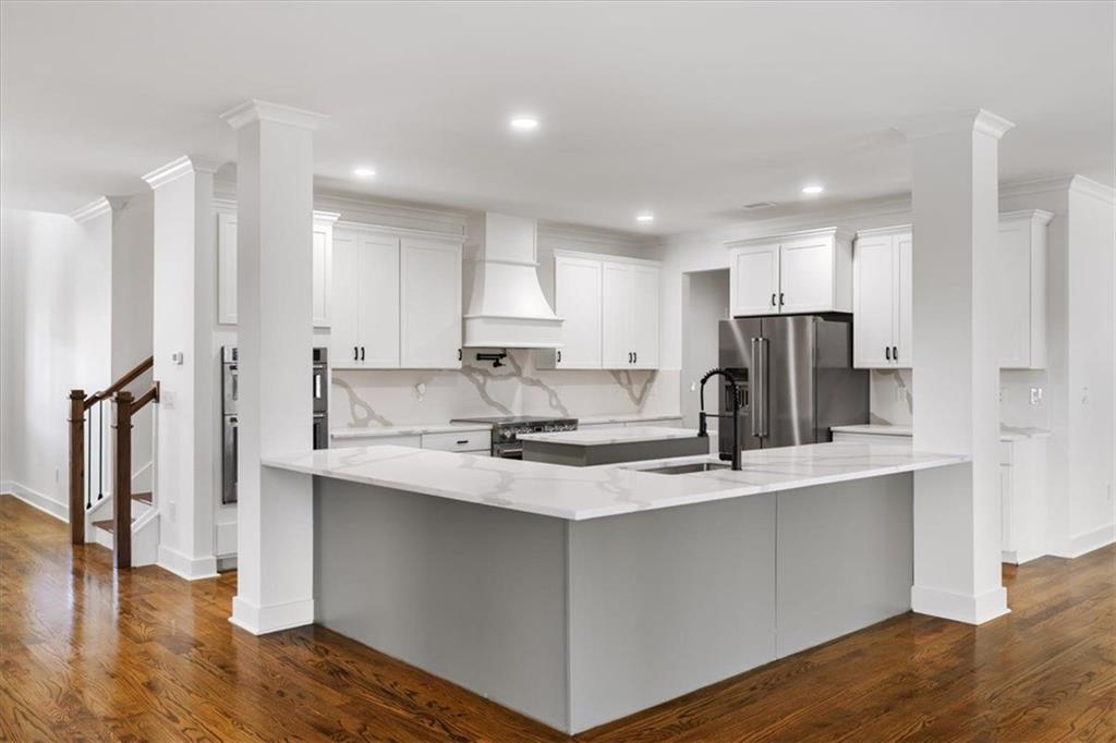 222 Silvercrest Drive Acworth, GA 30101 - Photo 8 of 73 a kitchen with stainless steel appliances granite countertop a refrigerator a sink a stove and a refrigerator with wooden floor