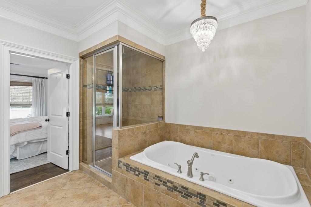 3585 Roxboro Road Northeast, Unit 6 Atlanta, GA 30326 - Photo 30 of 51 a bathroom with a tub a sink and a large mirror