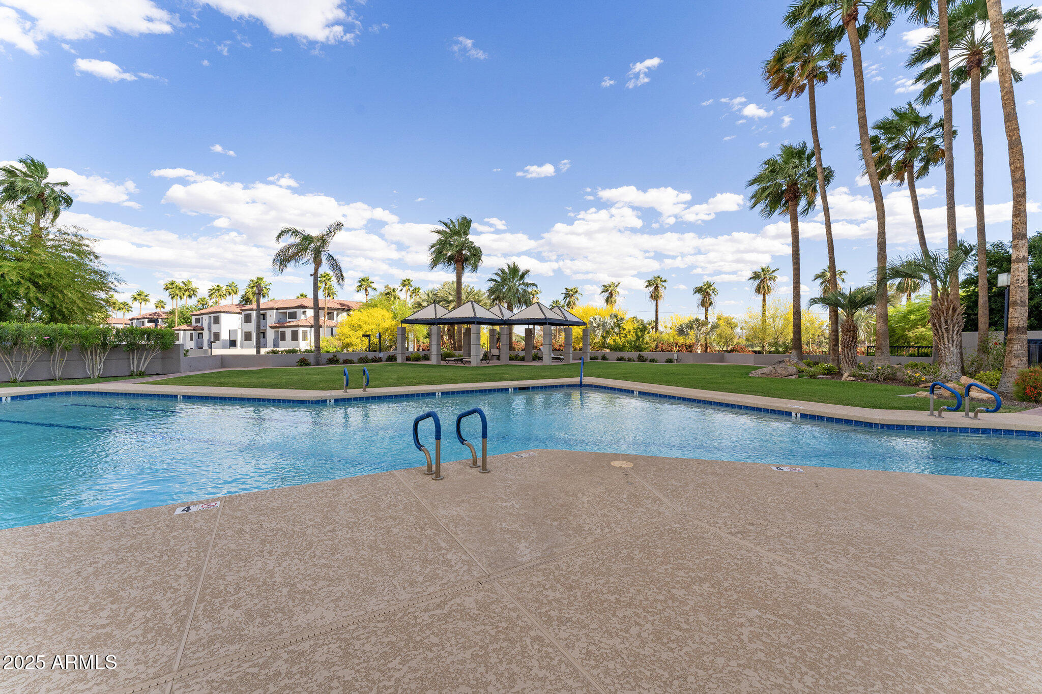 1040 East Osborn Road, Unit 1103 Phoenix, AZ 85014 - Photo 42 of 49 a view of swimming pool with outdoor seating and lake view