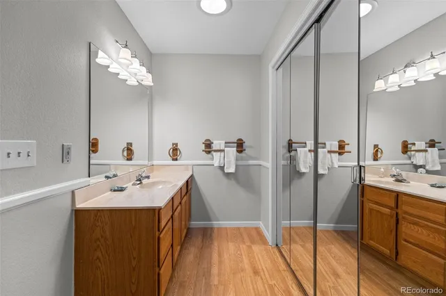 a bathroom with a sink a faucet a mirror and shower