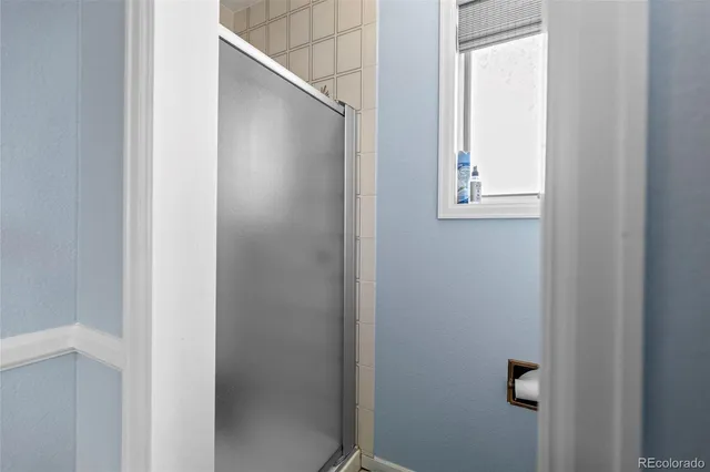 a bathroom with a glass shower door