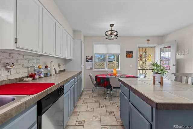 a kitchen with a stove a sink and a refrigerator