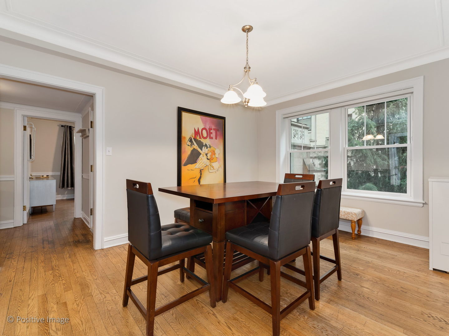3608 North Pine Grove Avenue, Unit 1M Chicago, IL 60613 - Photo 12 of 24 a view of a dining room with furniture window and wooden floor