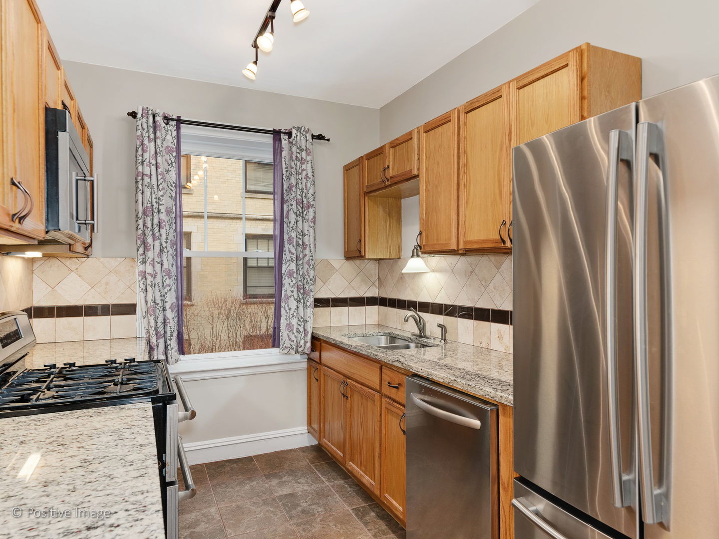 3608 North Pine Grove Avenue, Unit 1M Chicago, IL 60613 - Photo 14 of 24 a kitchen with a refrigerator stove and sink