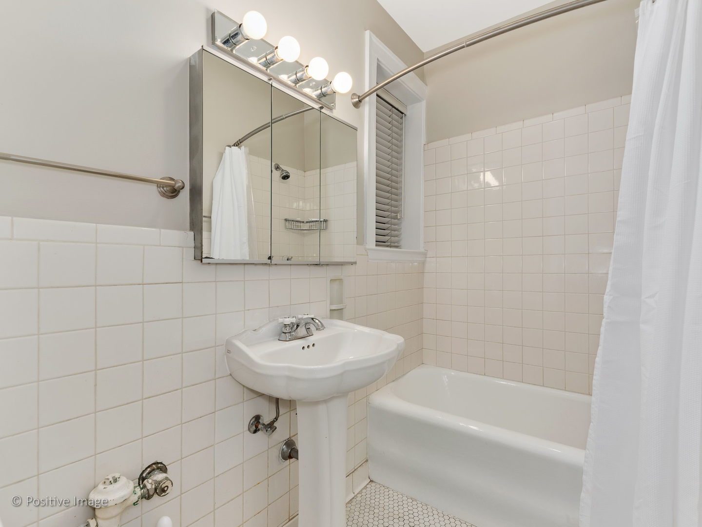 3608 North Pine Grove Avenue, Unit 1M Chicago, IL 60613 - Photo 19 of 24 a bathroom with a sink a toilet and shower