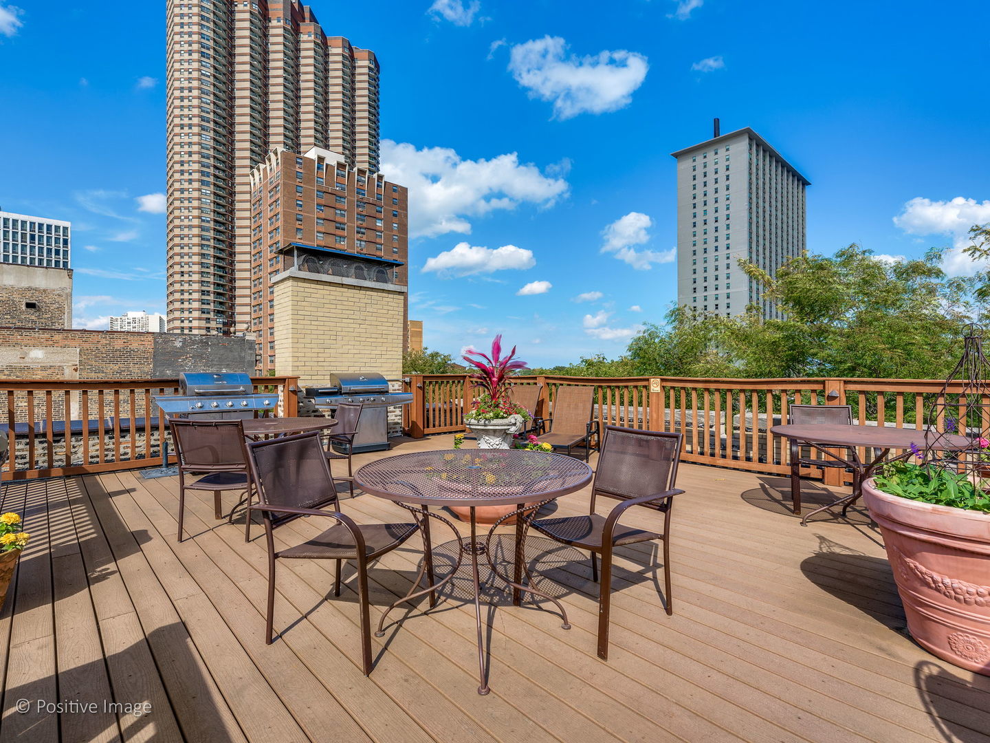 3608 North Pine Grove Avenue, Unit 1M Chicago, IL 60613 - Photo 22 of 24 a view of a roof deck with table and chairs couches and wooden floor