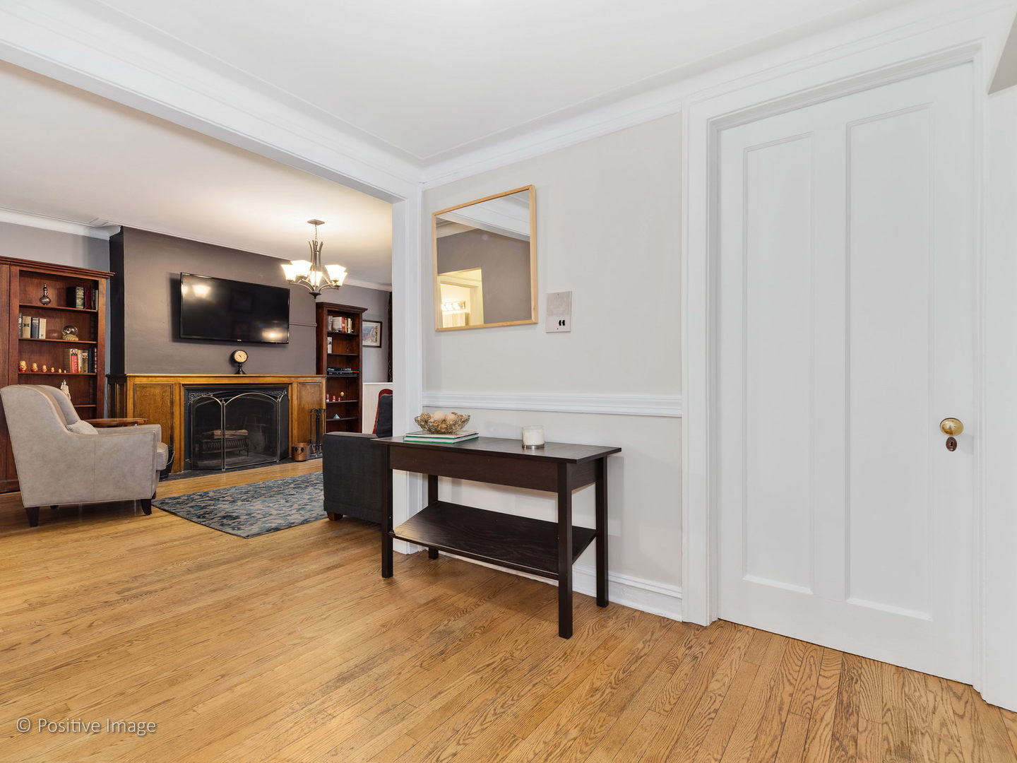 3608 North Pine Grove Avenue, Unit 1M Chicago, IL 60613 - Photo 4 of 24 a living room with furniture a fireplace and a flat screen tv