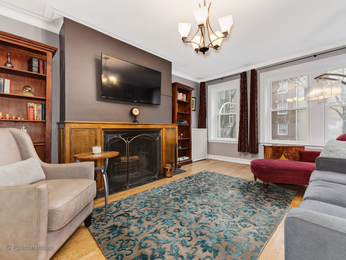 3608 North Pine Grove Avenue, Unit 1M Chicago, IL 60613 - Photo 6 of 24 a living room with furniture a flat screen tv and a fireplace