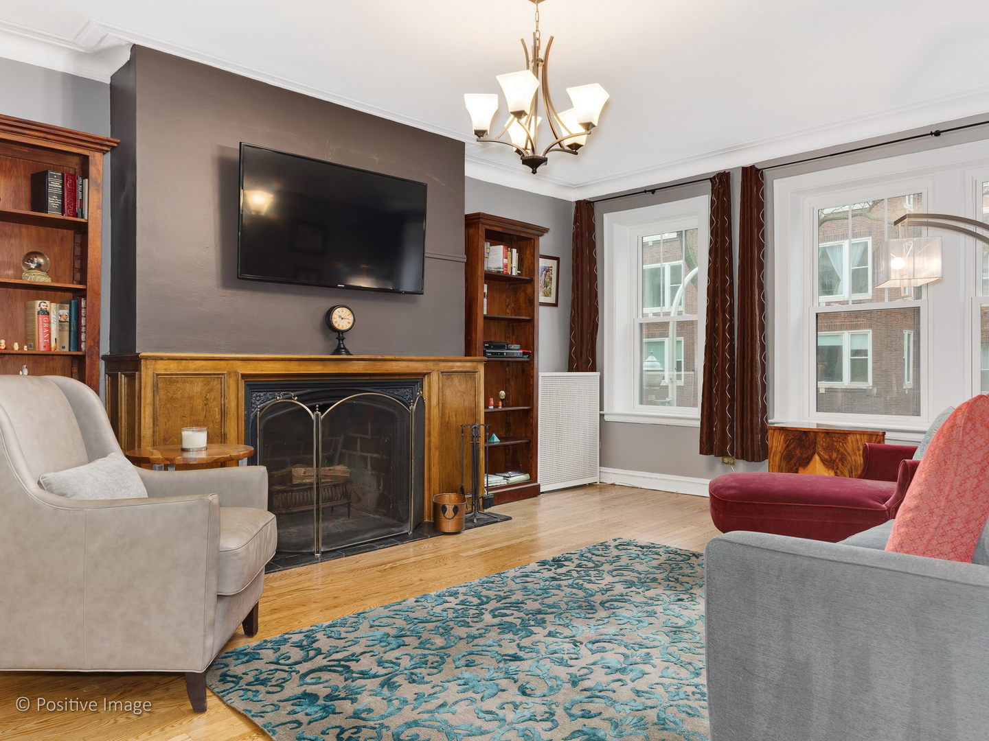3608 North Pine Grove Avenue, Unit 1M Chicago, IL 60613 - Photo 9 of 24 a living room with furniture and a flat screen tv