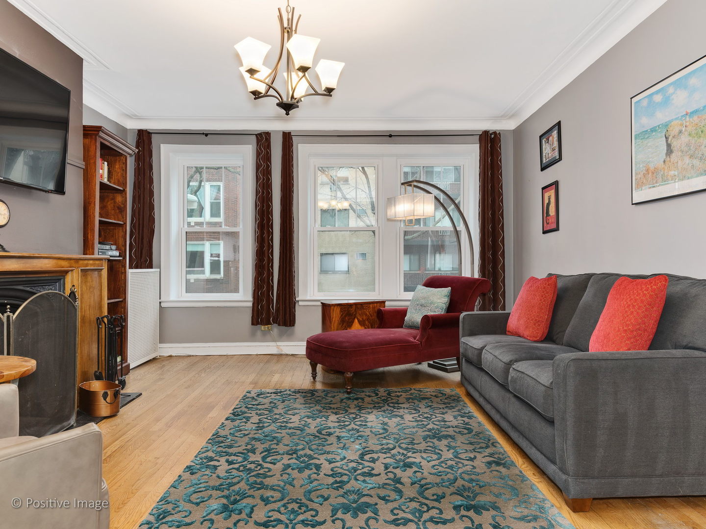 3608 North Pine Grove Avenue, Unit 1M Chicago, IL 60613 - Photo 10 of 24 a living room with furniture a fireplace and a flat screen tv