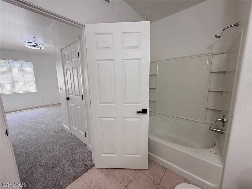 9050 West Warm Springs Road, Unit 2002 Las Vegas, NV 89148 - Photo 25 of 46 This primary bath features a combination shower and tub, with an adjoining room for spacious living.
