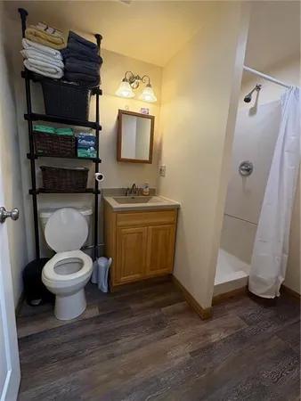 a bathroom with a toilet sink and mirror