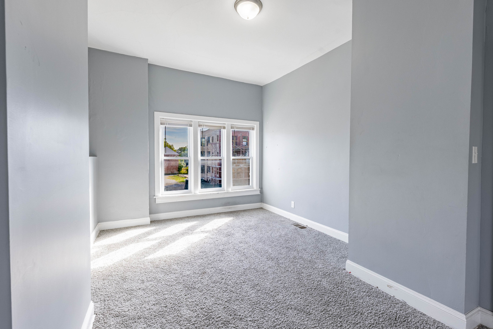 1908 South Sawyer Avenue Chicago, IL 60623 - Photo 14 of 31 an empty room with windows