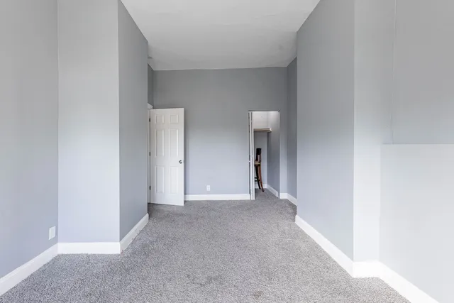 a view of an empty room and closet area