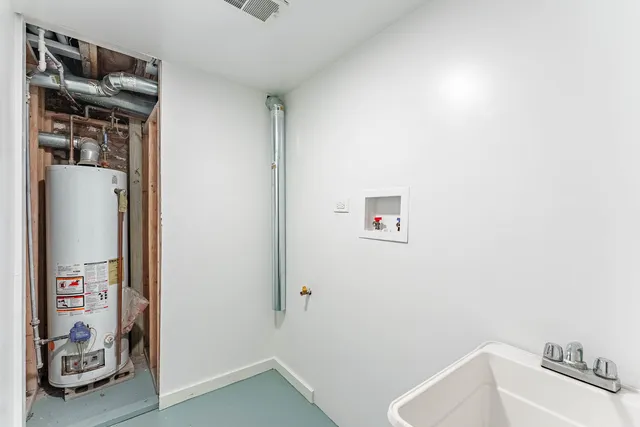 a bathroom with a refrigerator and a sink