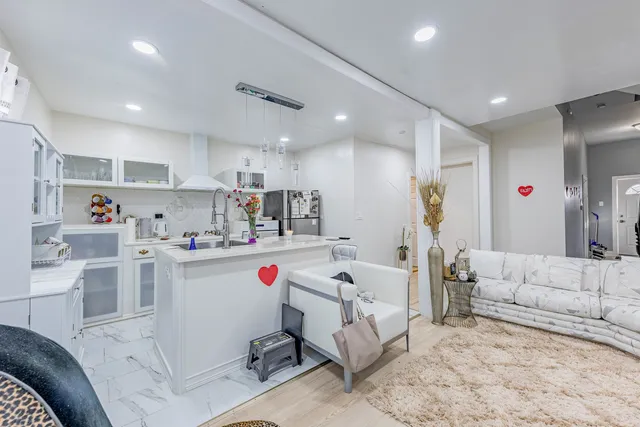 a living room with furniture and kitchen view