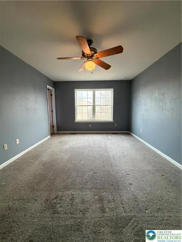 a view of room window and ceiling fan