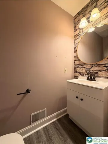 a bathroom with a sink mirror and vanity