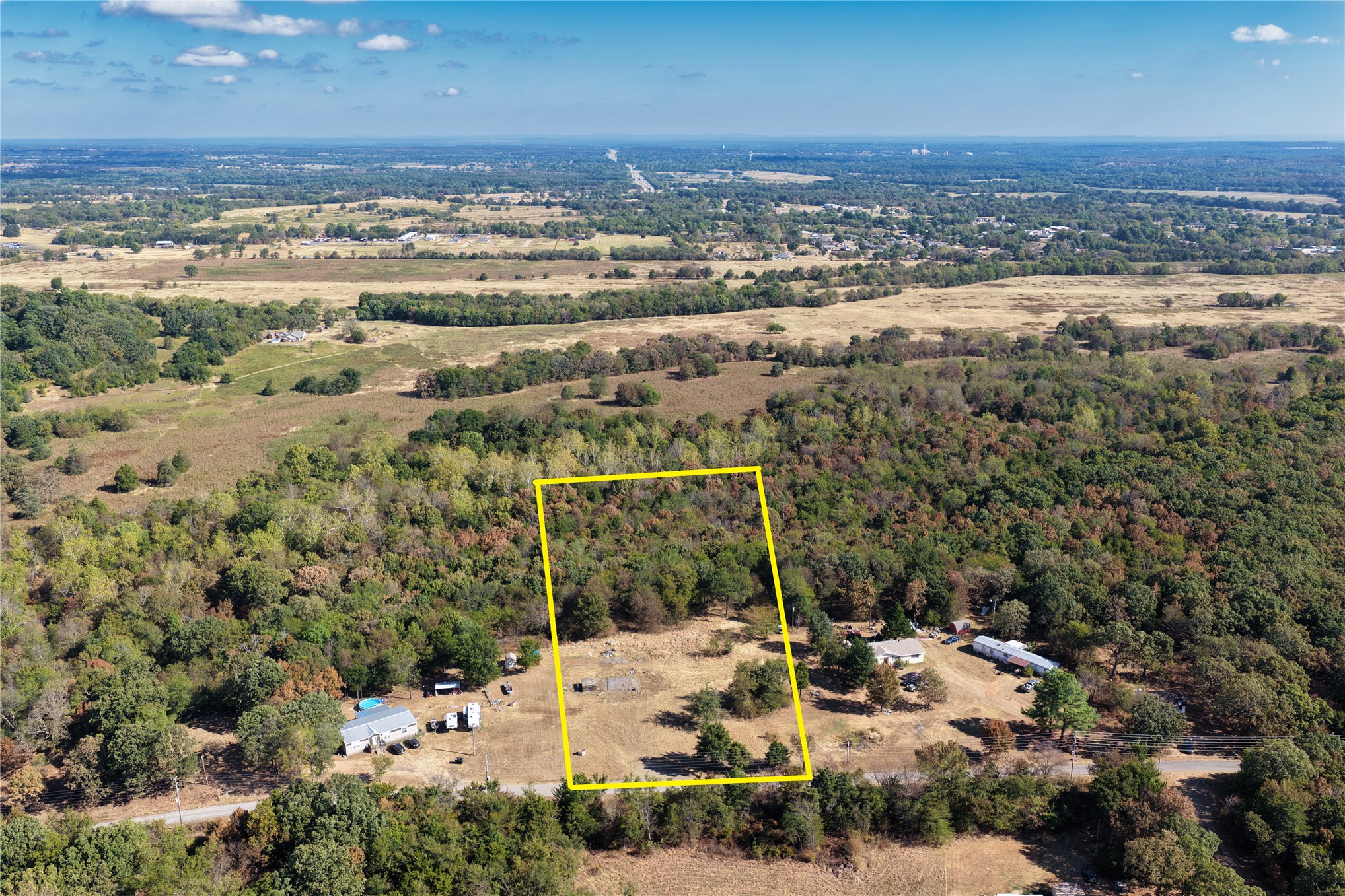 Expansive undeveloped land featuring mature trees and open clearings