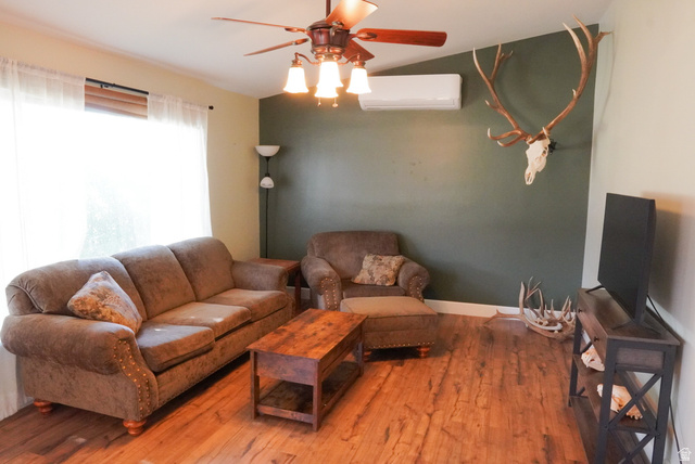 324 Stringtown Road Georgetown, ID 83239 - Photo 16 of 49 Living area with wood finished floors, ceiling fan, and a wall mounted air conditioner