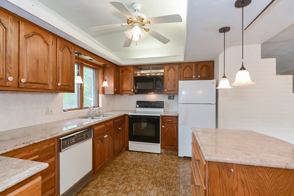 12 Catherine Road Framingham, MA 01701 - Photo 11 of 40 a kitchen with stainless steel appliances granite countertop a stove top oven a refrigerator a sink and dishwasher