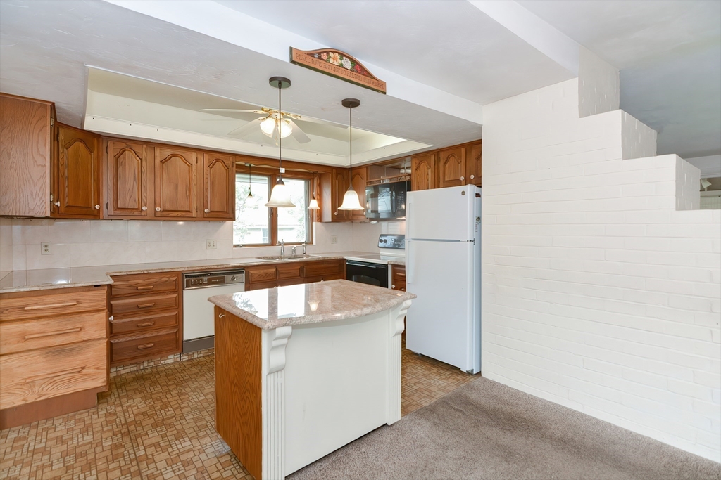 12 Catherine Road Framingham, MA 01701 - Photo 7 of 40 a kitchen with refrigerator and cabinets